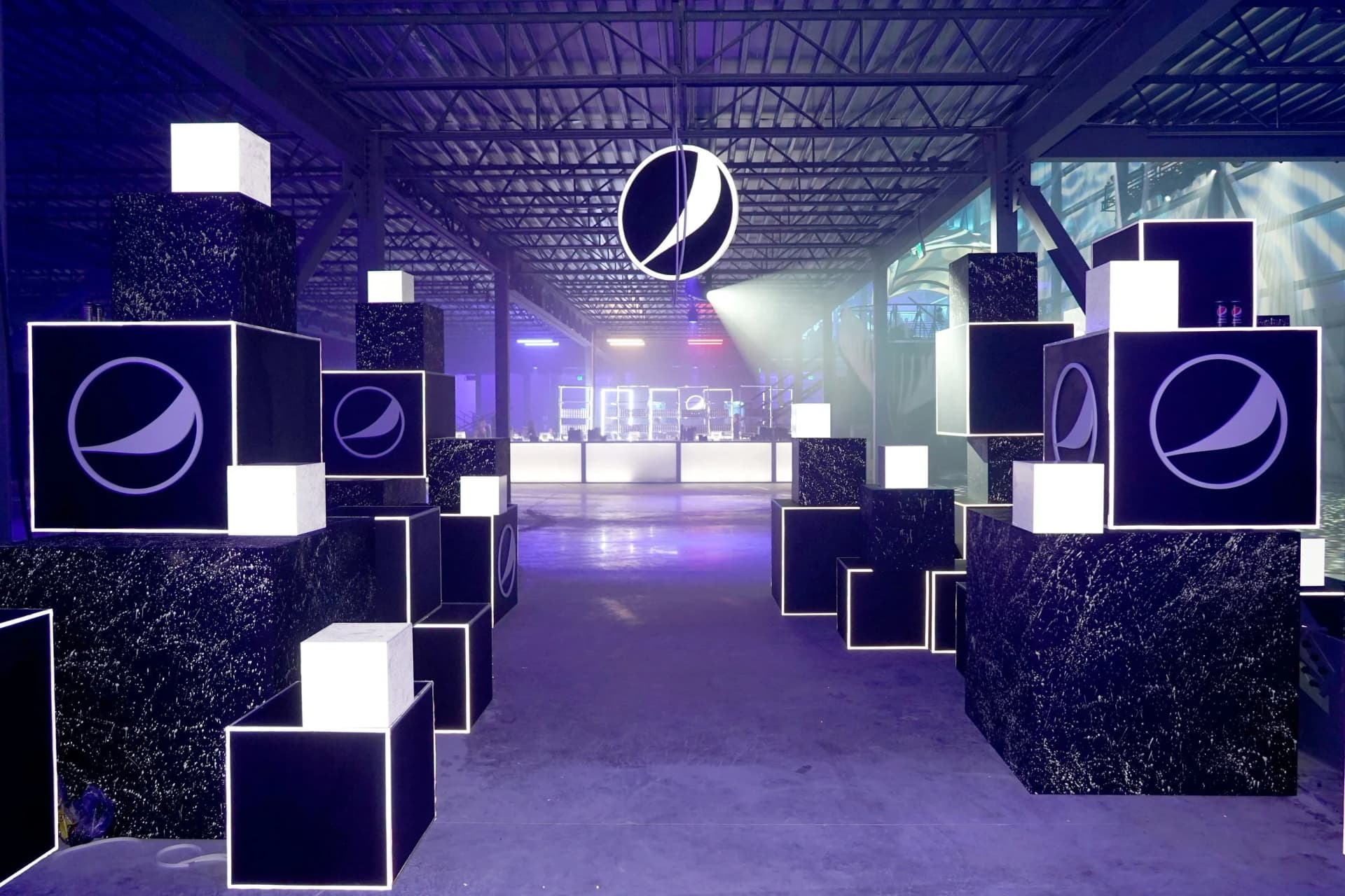 branded cube installation with illuminated displays for event environment