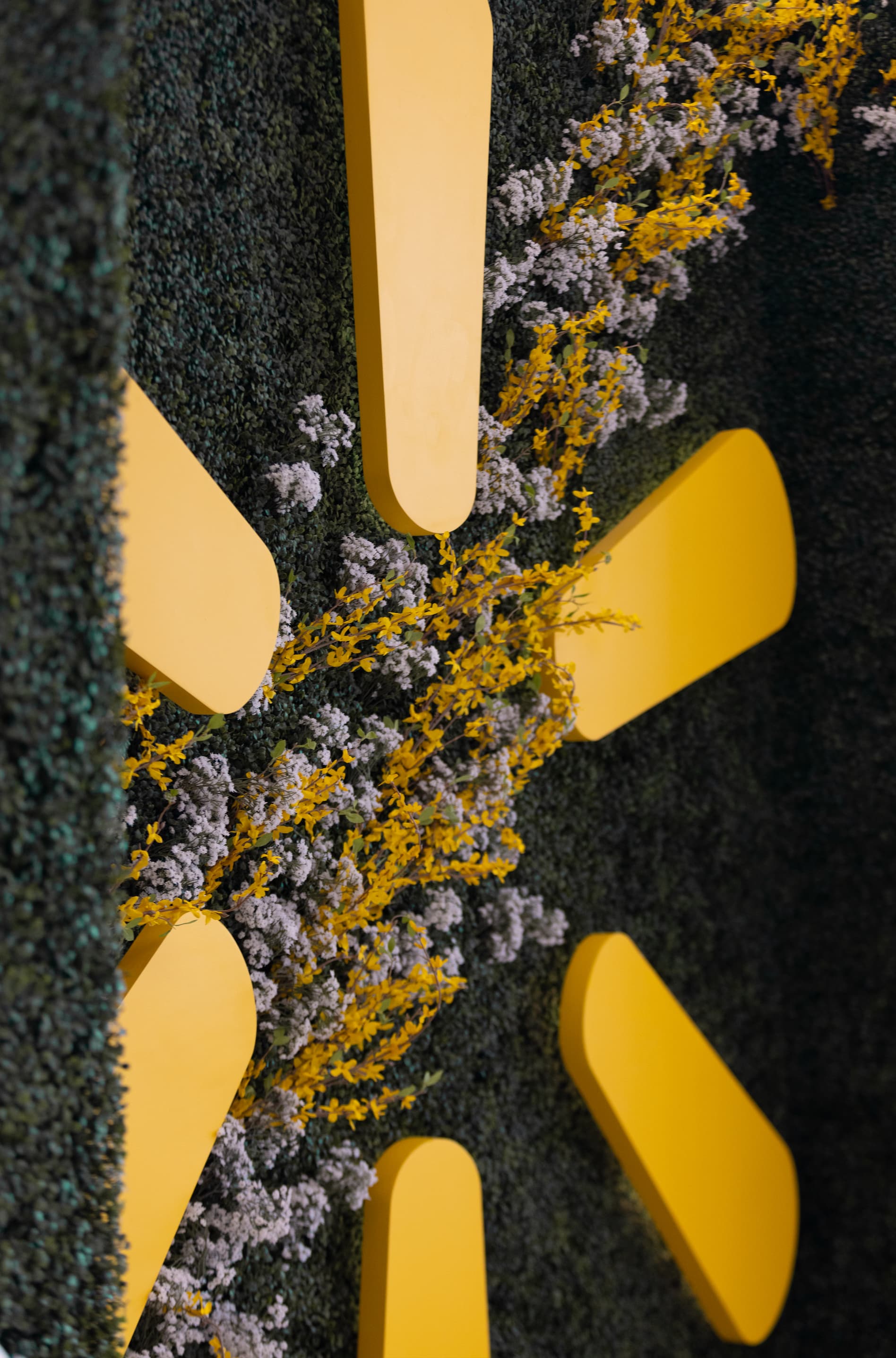 close up of dimensional logo elements on custom greenery wall