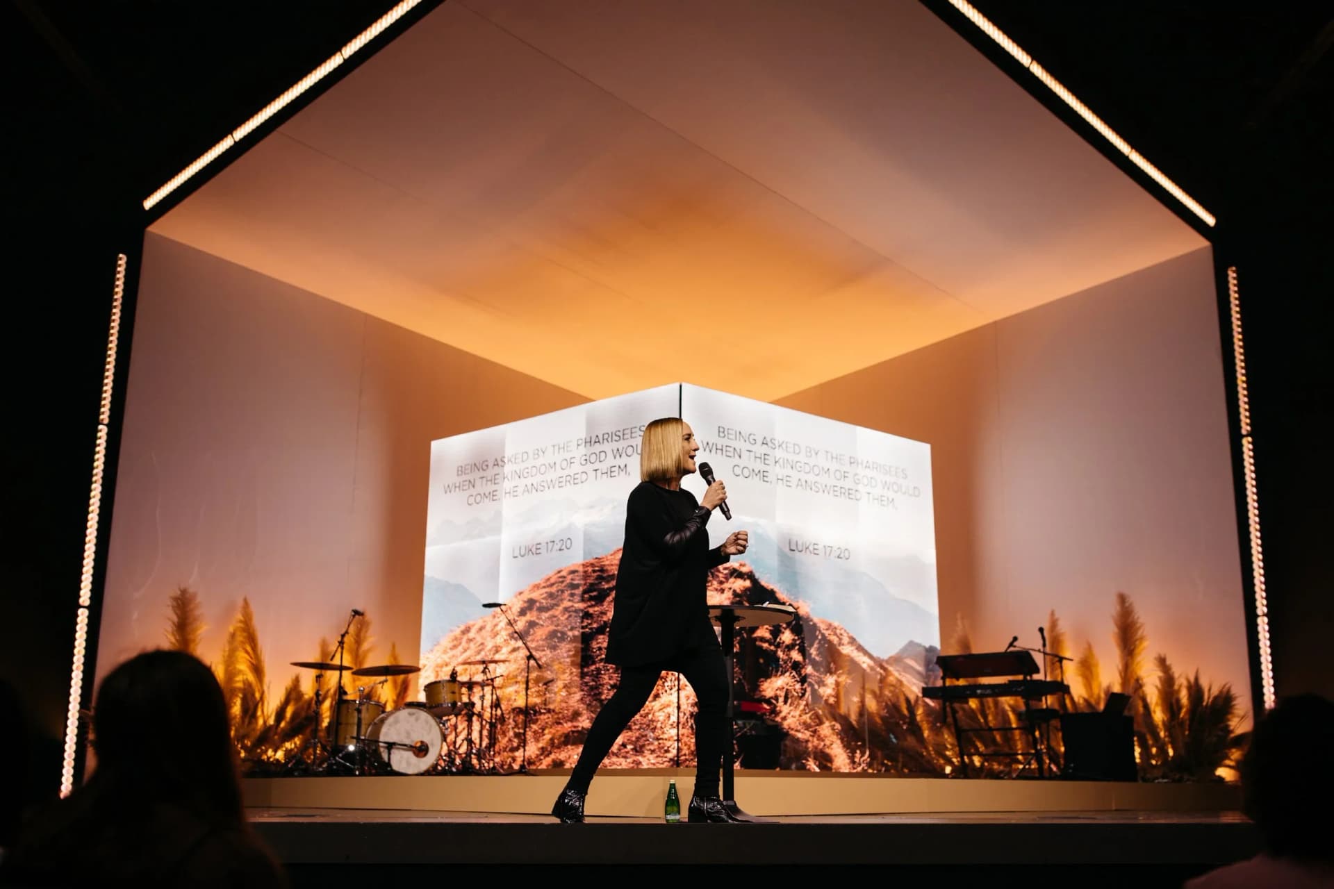 house shaped scenic stage frame with projected landscape backdrop