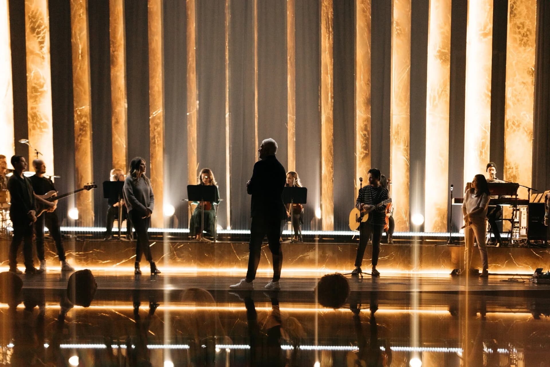 live performance stage with illuminated vertical scenic panels