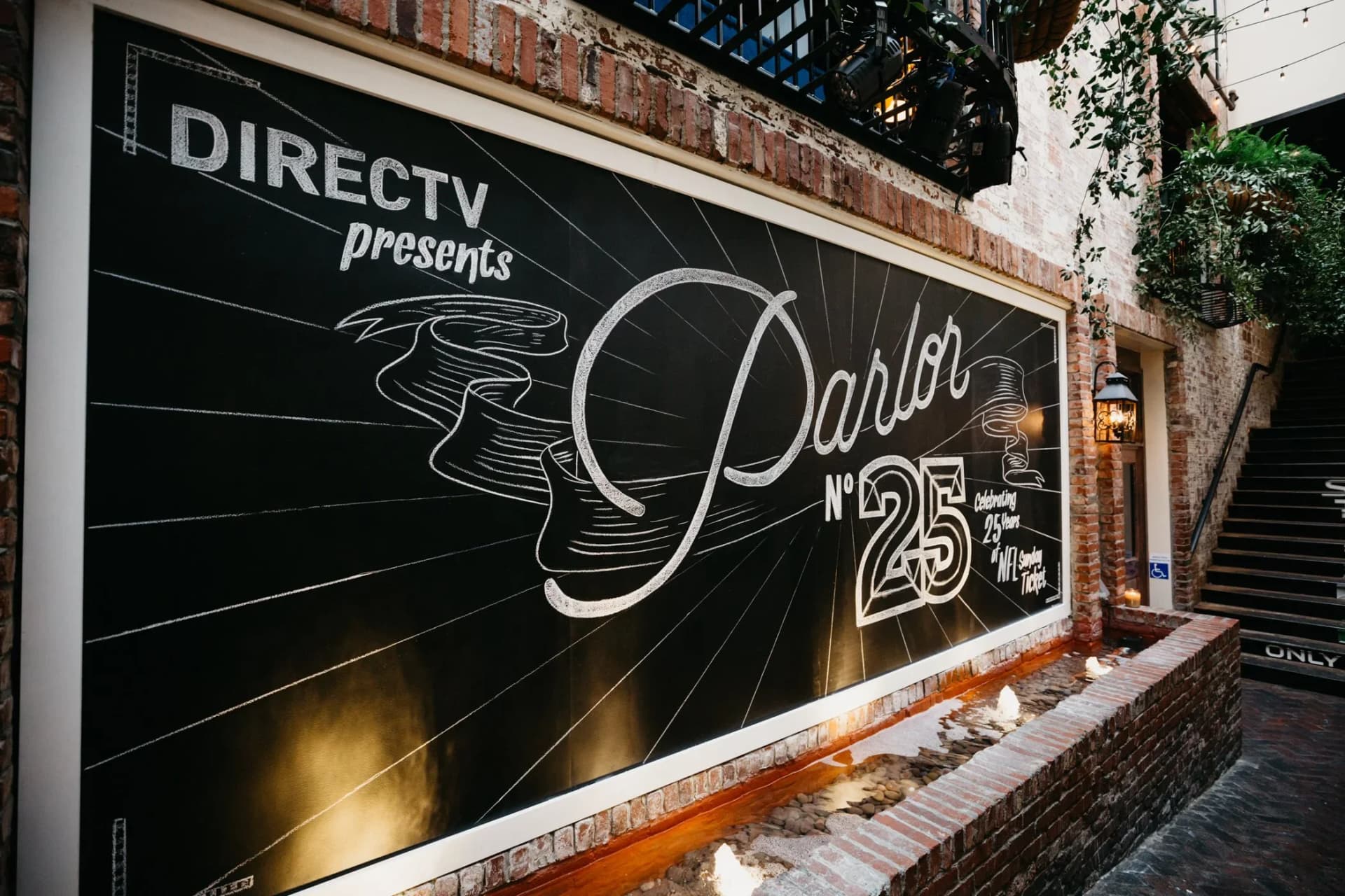 outdoor branded mural wall with custom graphics and event lighting
